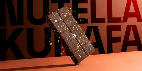 Chocolate bar with gold specks on a red background with 'NUTELLA' branding.