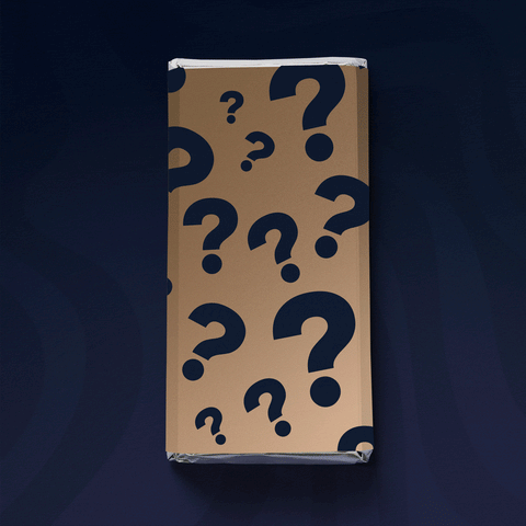 mystery chocolate block wrapped in tan paper covered with black question marks against dark background.